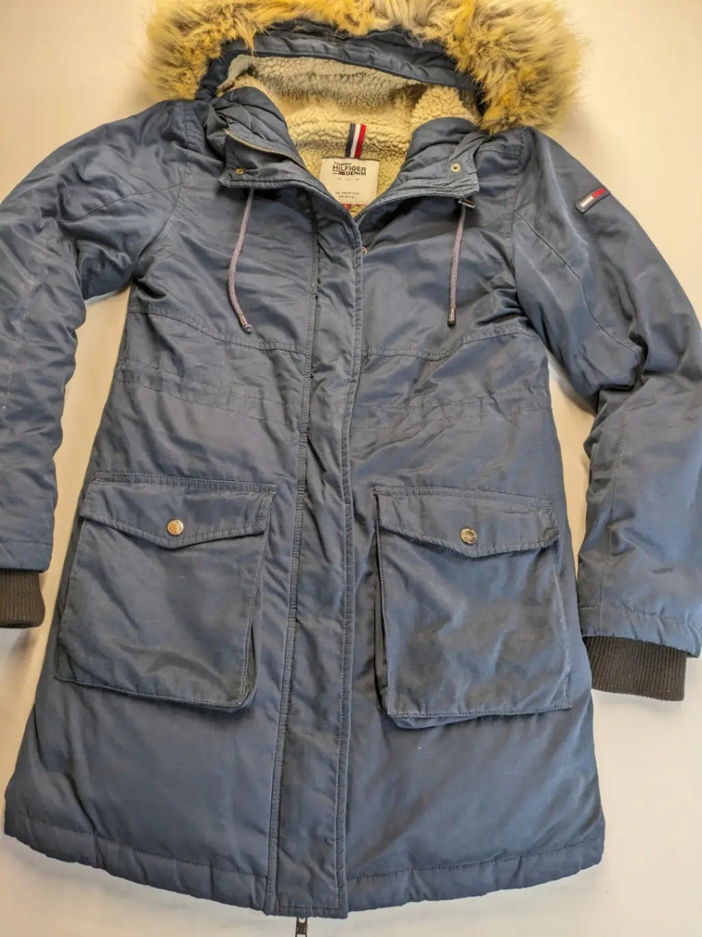 Tommy Hilfiger Denim blue parka coat with faux fur hood and Sherpa lining.