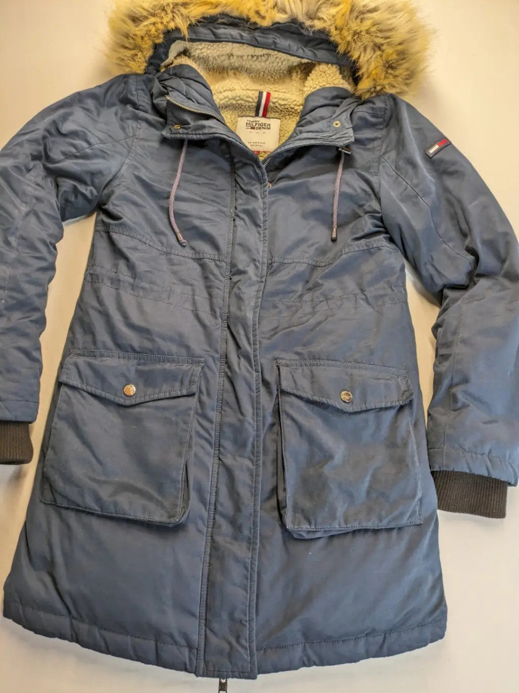 Tommy Hilfiger Denim blue parka coat with faux fur hood and Sherpa lining.