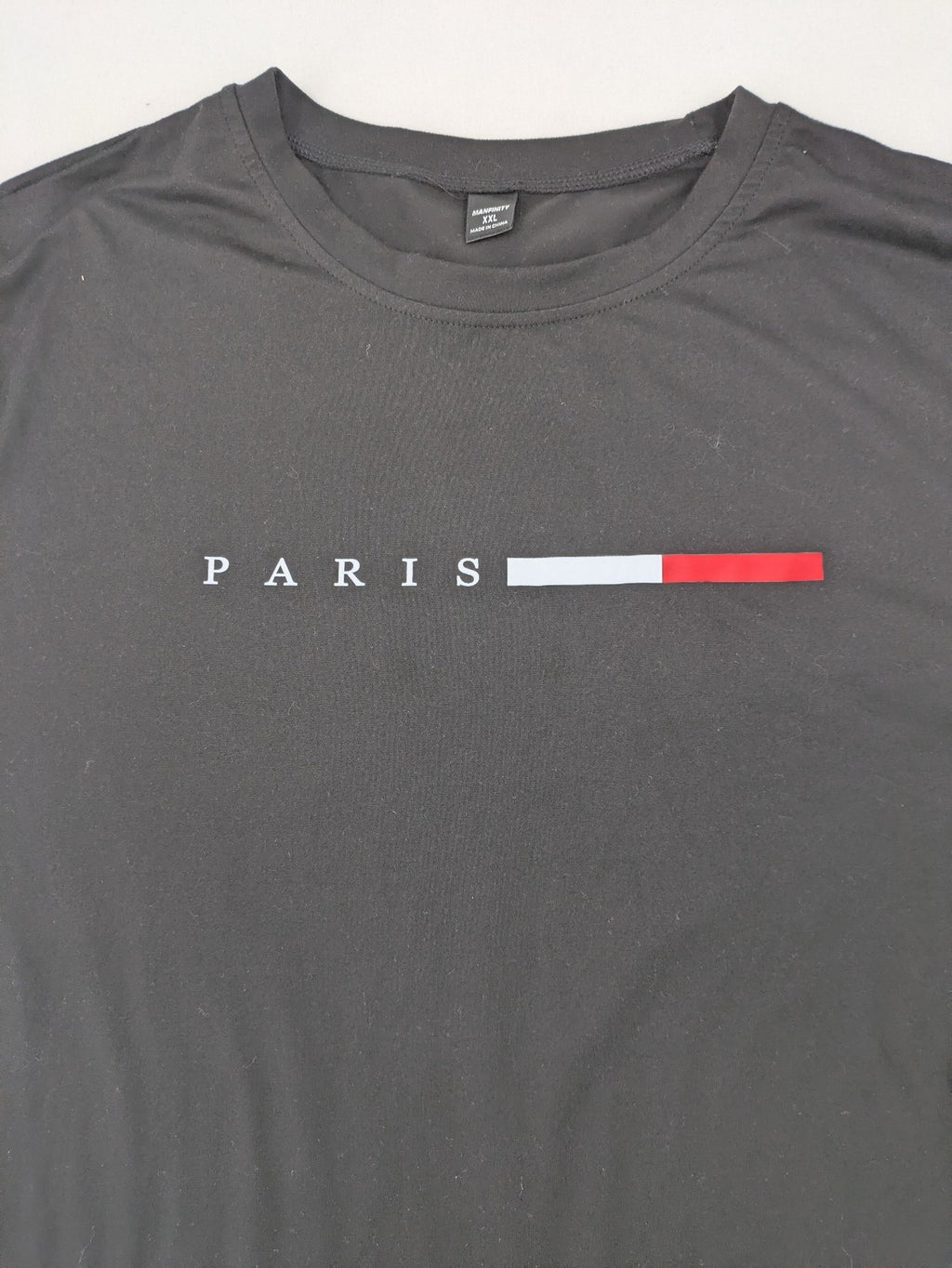 Manfinity loungewear set black T-shirt and shorts with Paris graphic print.