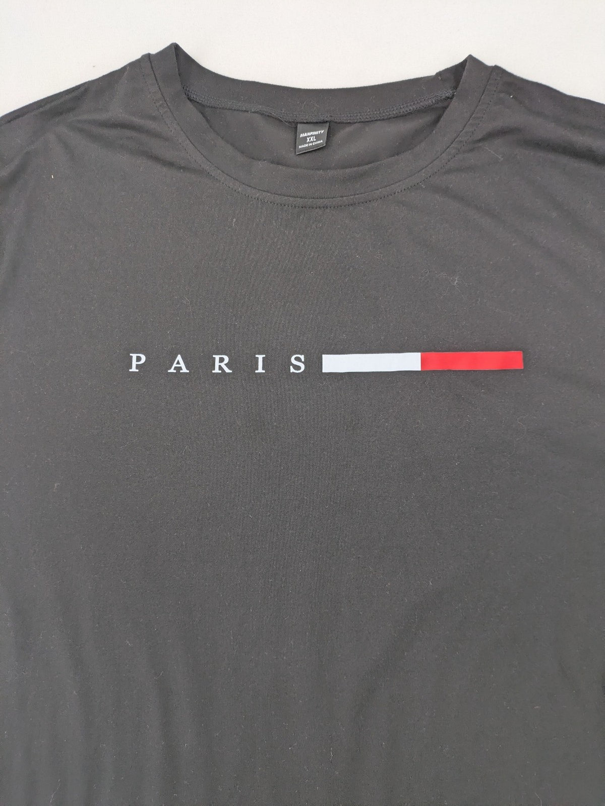 Manfinity loungewear set black T-shirt and shorts with Paris graphic print.