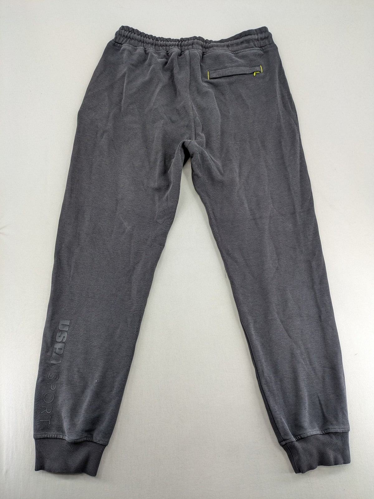 US Polo Assn grey sweatpants with light green drawstring and subtle logo detail.