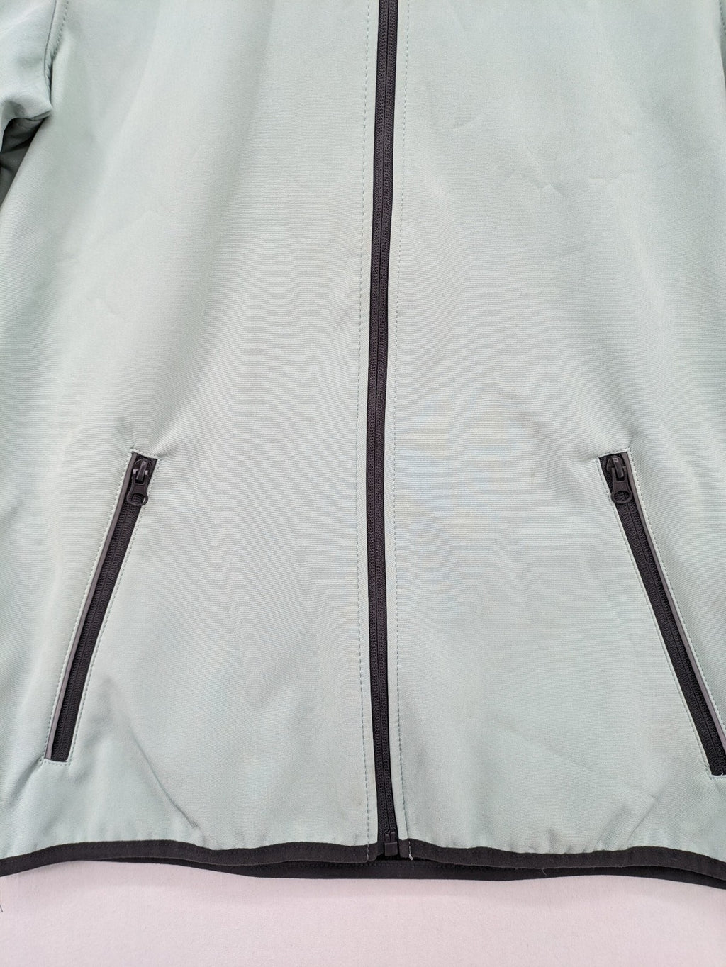 YFK outdoor jacket mint green softshell with dark grey fleece lining and hood.
