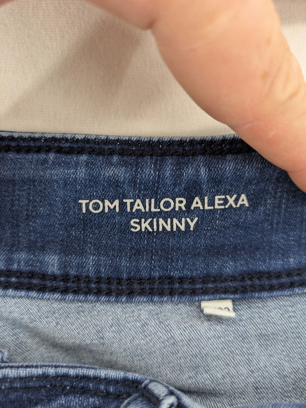 Tom Tailor blue skinny jeans with classic 5-pocket design and double button closure.