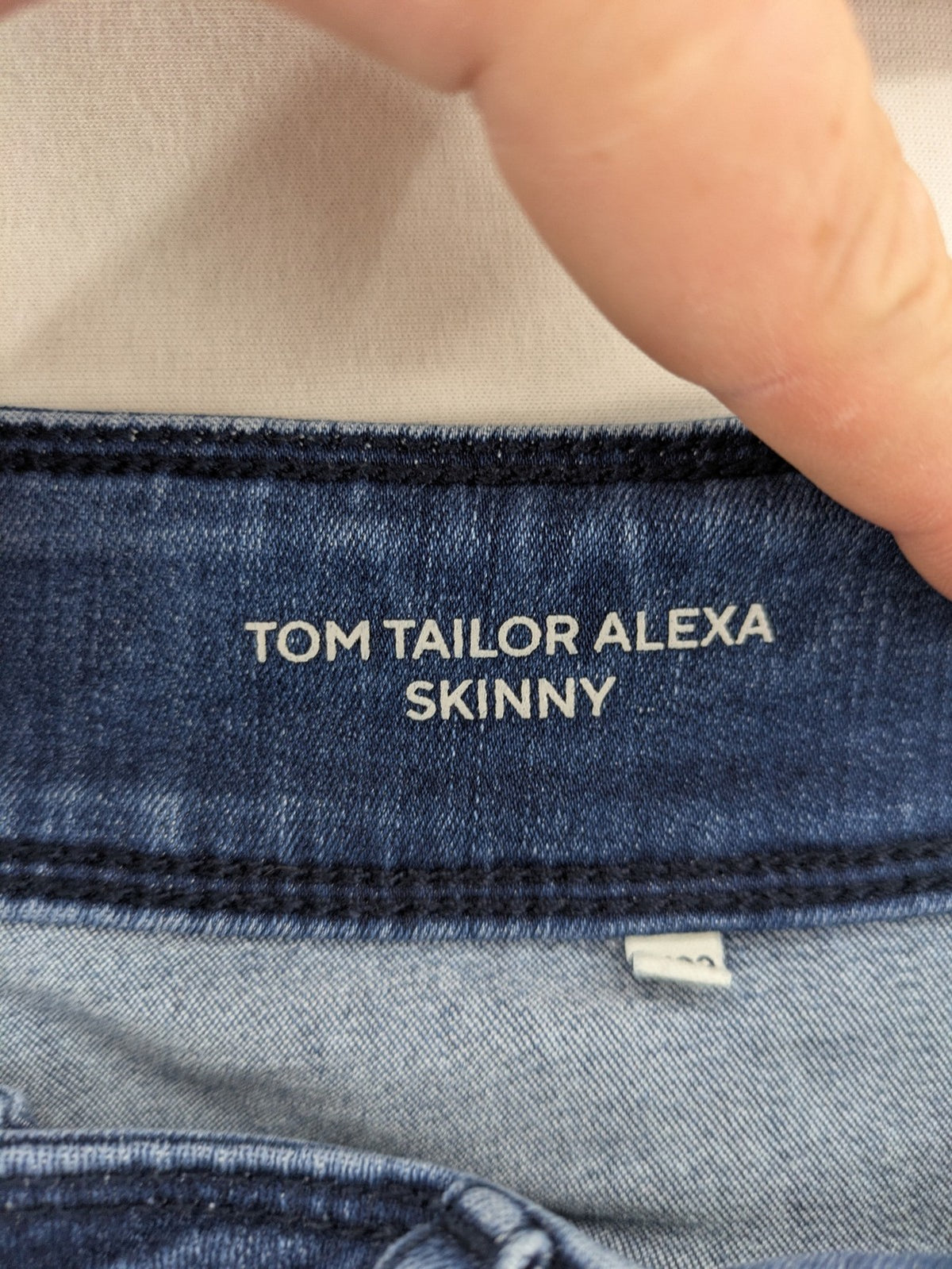 Tom Tailor blue skinny jeans with classic 5-pocket design and double button closure.