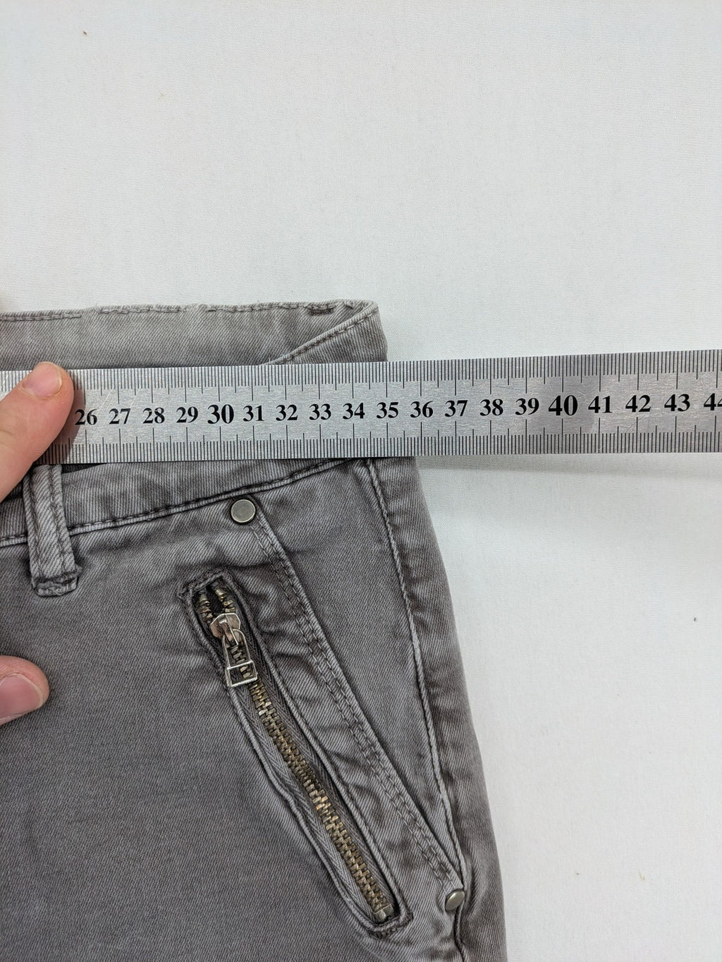 Made in Italy grey biker jeans with zip pockets and structured knee detailing.