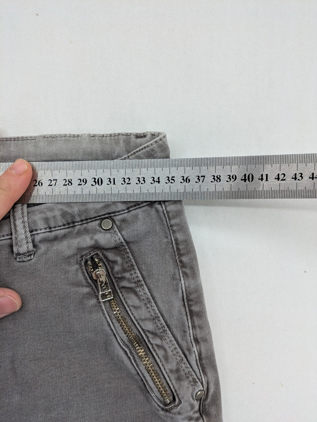 Made in Italy grey biker jeans with zip pockets and structured knee detailing.
