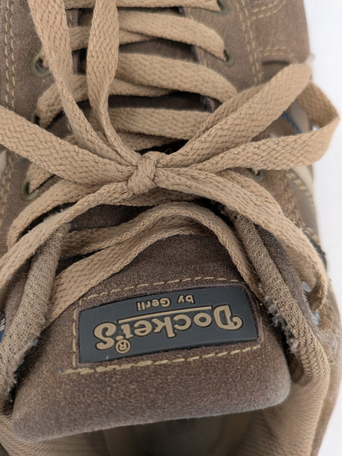 Dockers brown sneakers with subtle light brown and blue accents, lace-up design.