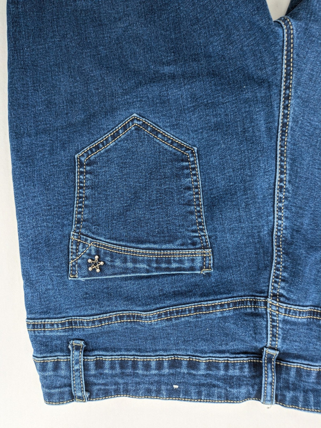 Miss Good blue straight jeans with 5-pocket design and decorative metal accent.