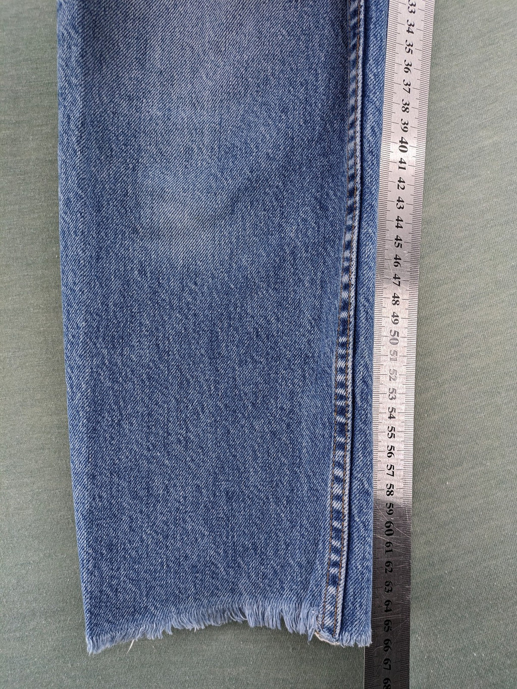 Re/Done blue straight jeans high rise with button fly and raw hem detail.