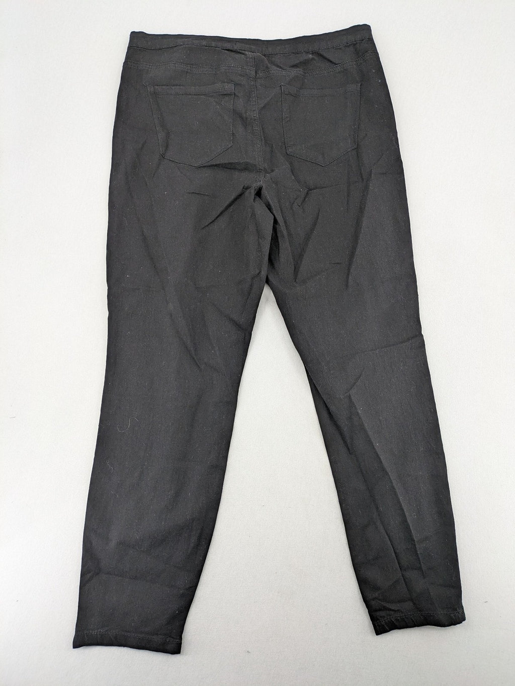 Denim & Co. black straight jeans with front button closure and back pockets.