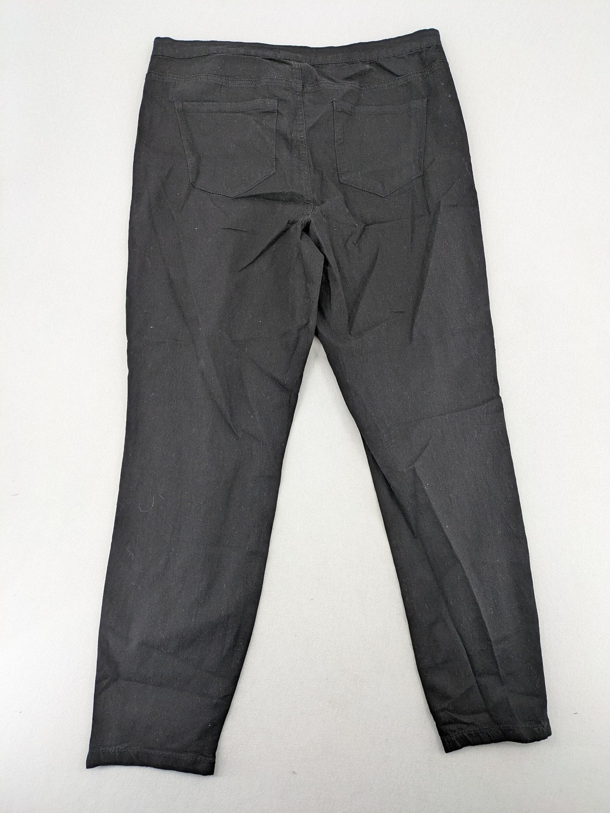Denim & Co. black straight jeans with front button closure and back pockets.