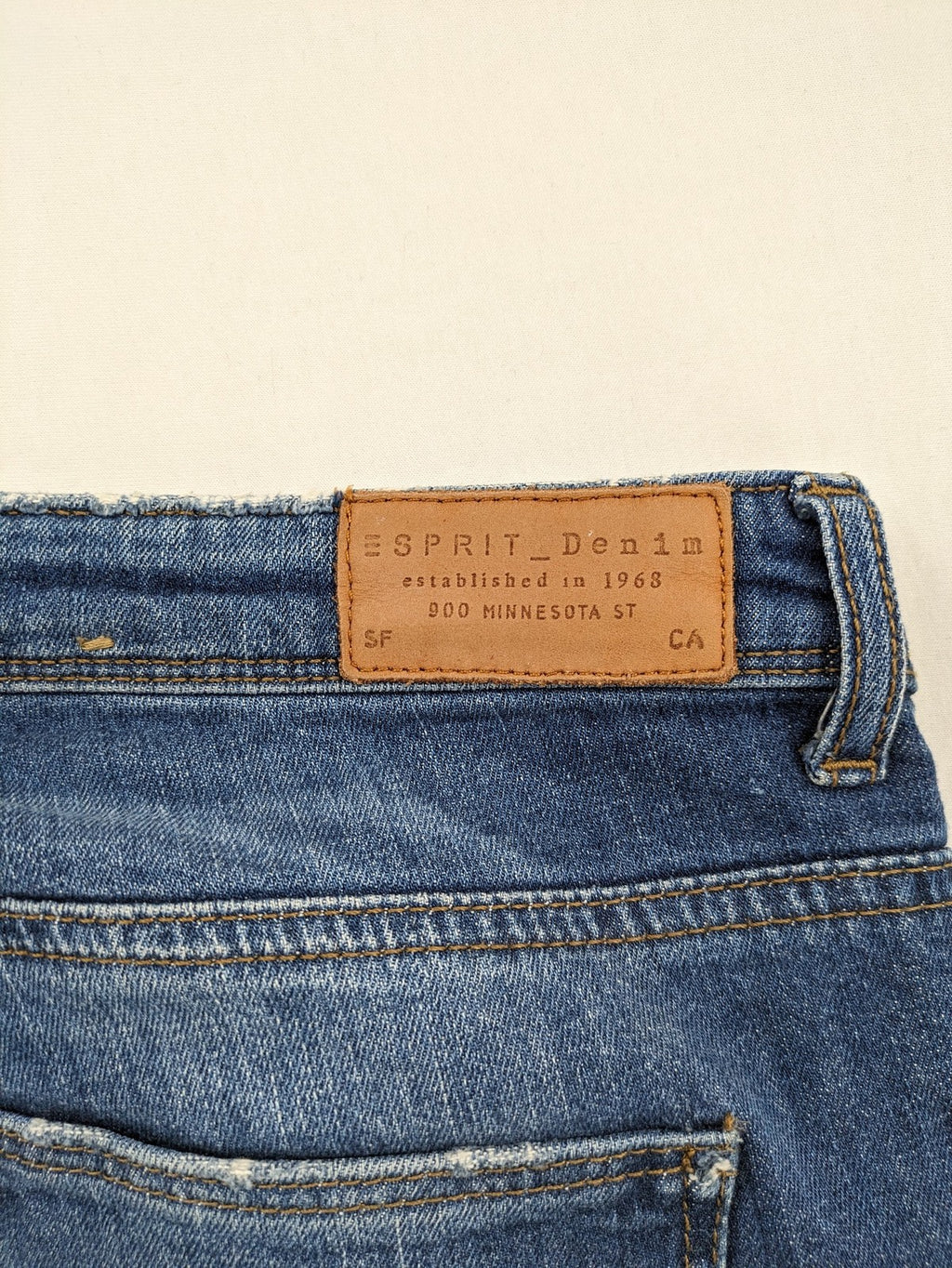 Esprit blue straight leg jeans with ripped knee details and rolled hem.