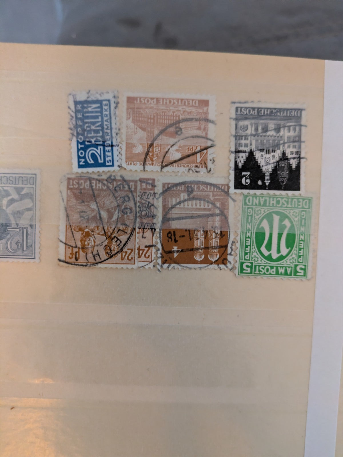 Beige postage stamp album featuring over 1000 stamps from Germany and Europe.