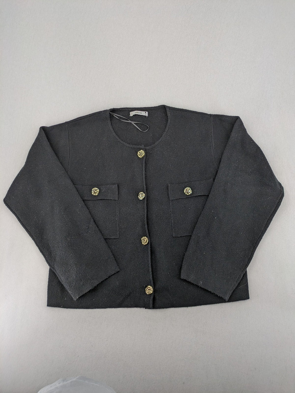 Reserved gold turtle neck jumper with black knit, gold button details and front pockets.