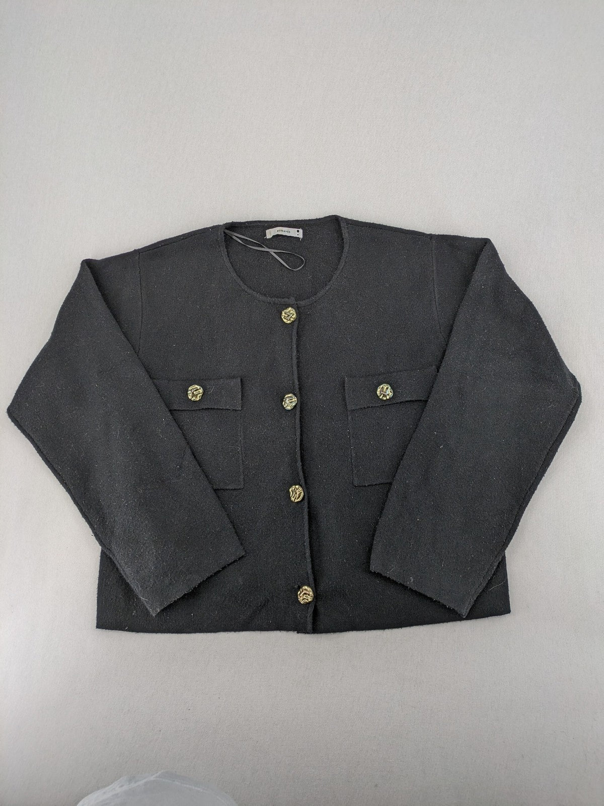 Reserved gold turtle neck jumper with black knit, gold button details and front pockets.