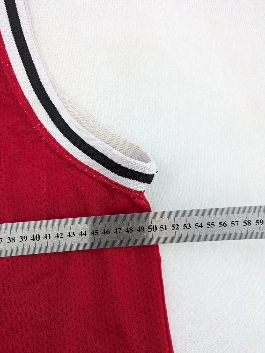 Spalding vintage red basketball jersey size XL, number 11, with black and white striped trim.