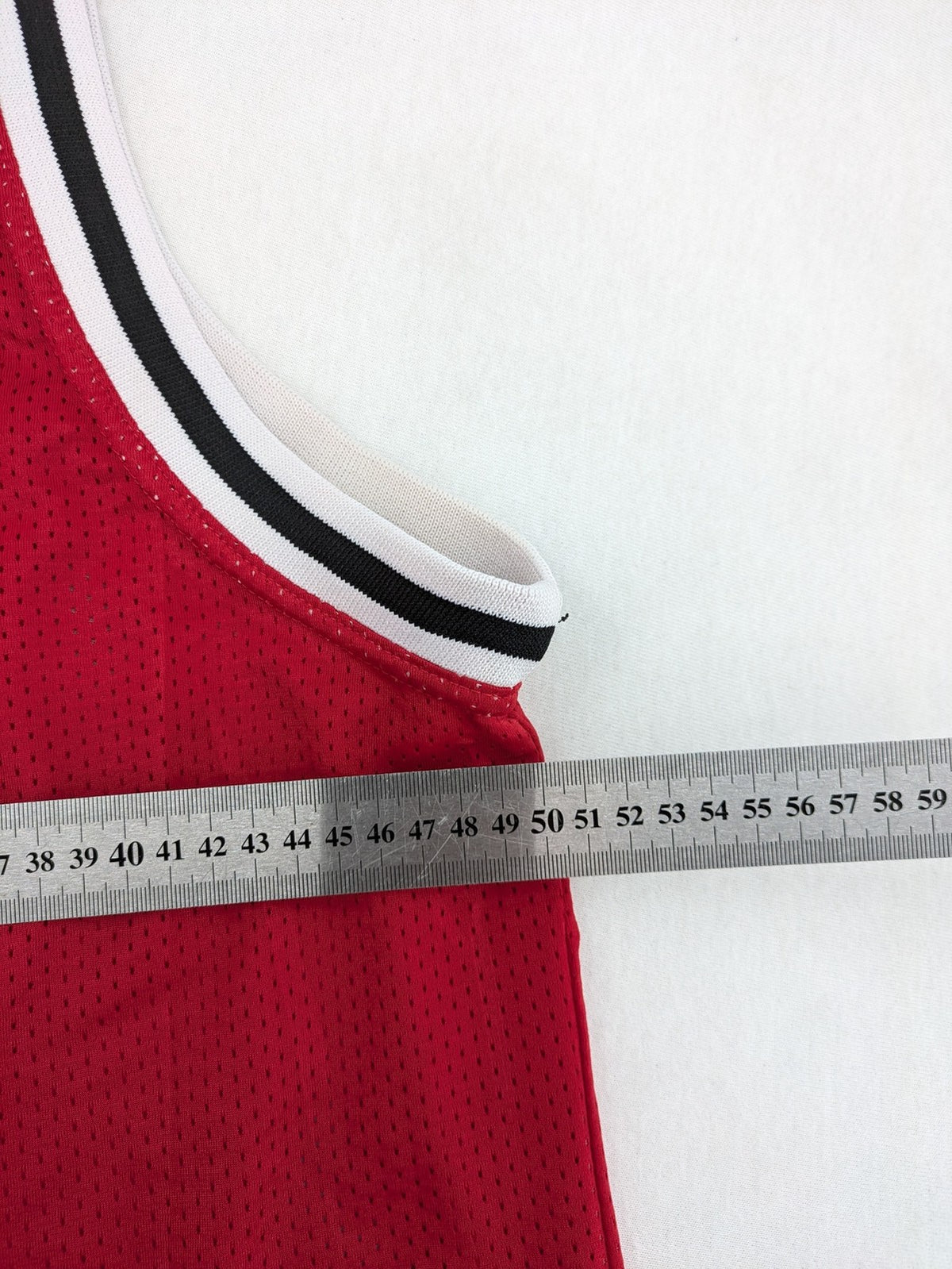 Spalding vintage red basketball jersey size XL, number 11, with black and white striped trim.