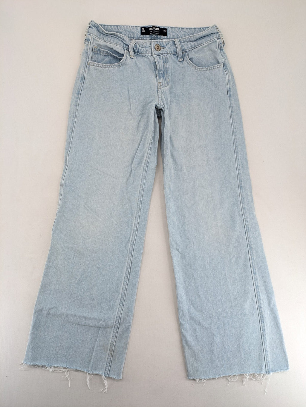 Hollister blue straight jeans low-rise baggy with raw hem and classic five-pocket design.