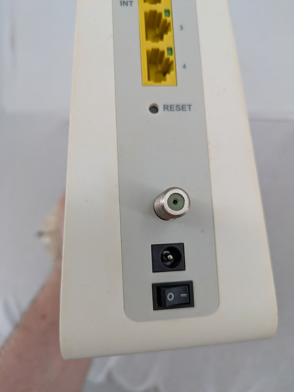 Compal beige WLAN modem router with integrated Wi-Fi and multiple LAN ports.