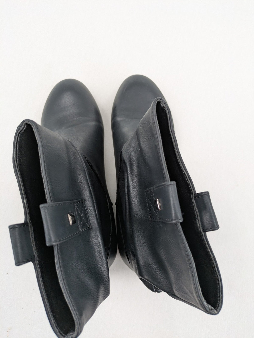 DAF black booties with decorative strap and studded details, made of faux leather.