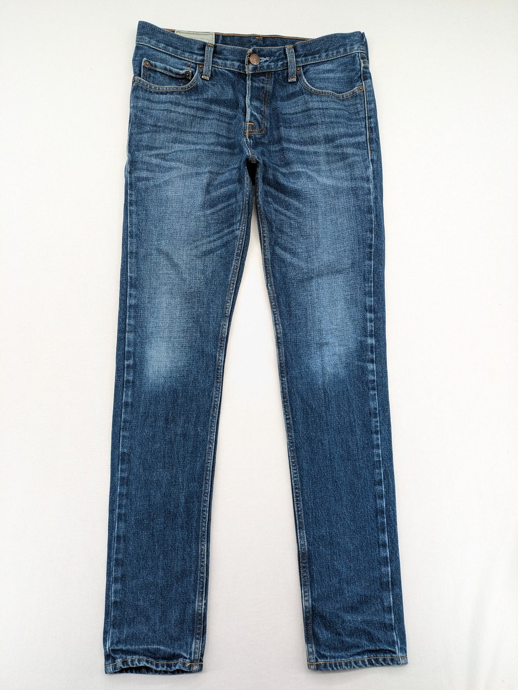 Hollister blue super skinny jeans medium wash button fly with faded details.