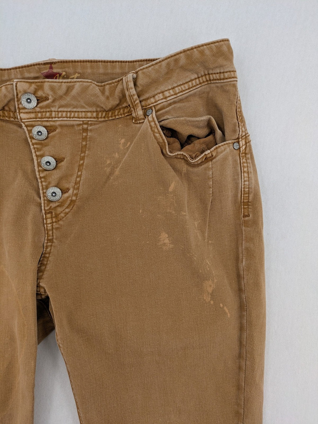 Buena Vista beige capri jeans with frayed hem and button fly detail.