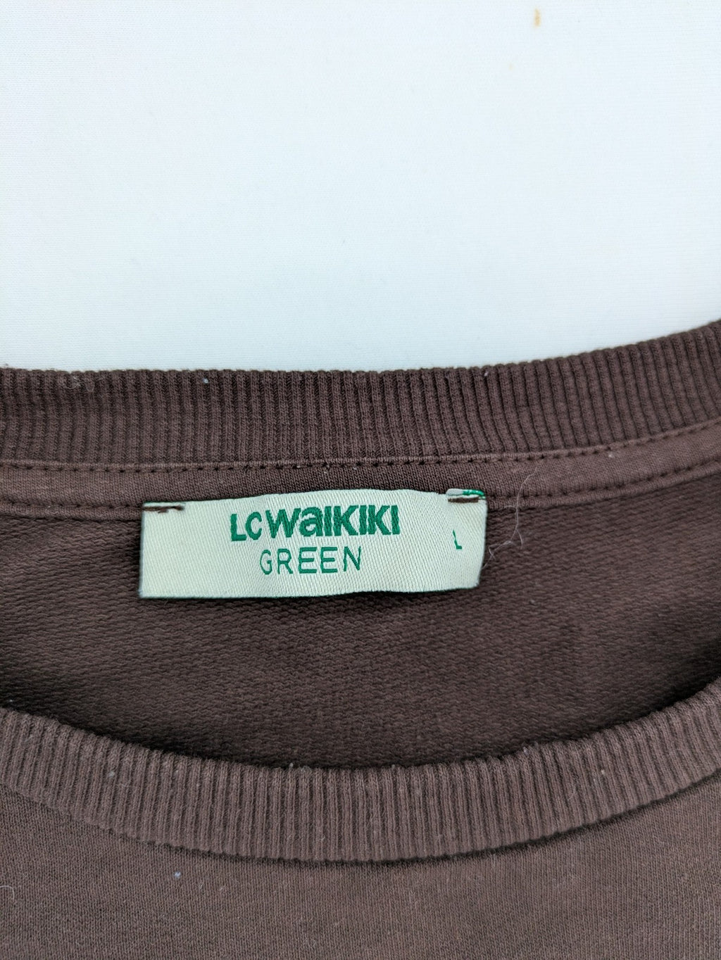 LC Waikiki green sweatshirt dress with minimalist white line art graphic and ribbed cuffs.