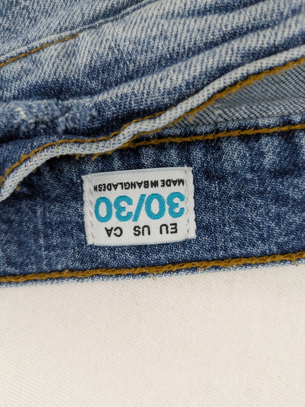 FSBN blue straight jeans with ripped distressed knees and classic button fly.