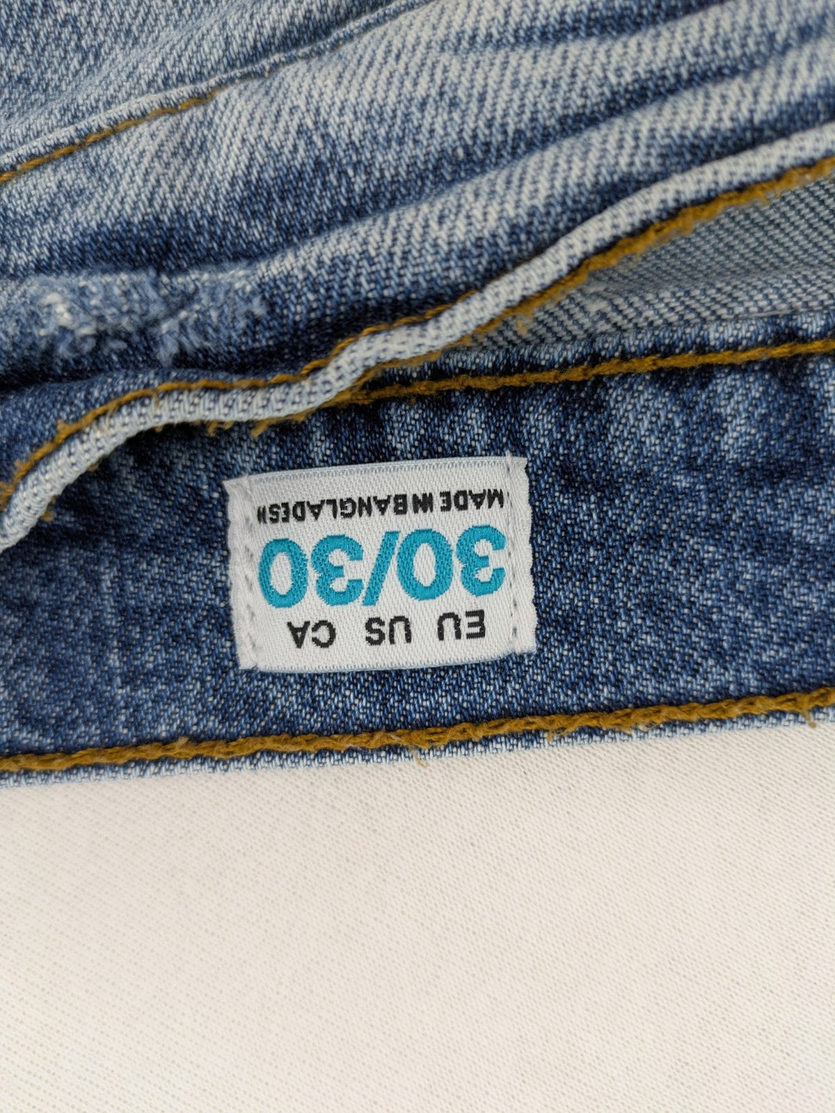 FSBN blue straight jeans with ripped distressed knees and classic button fly.