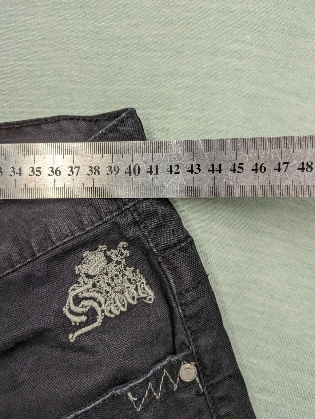 Savvy black pants straight fit with button fly, embroidered details and unique stitching.