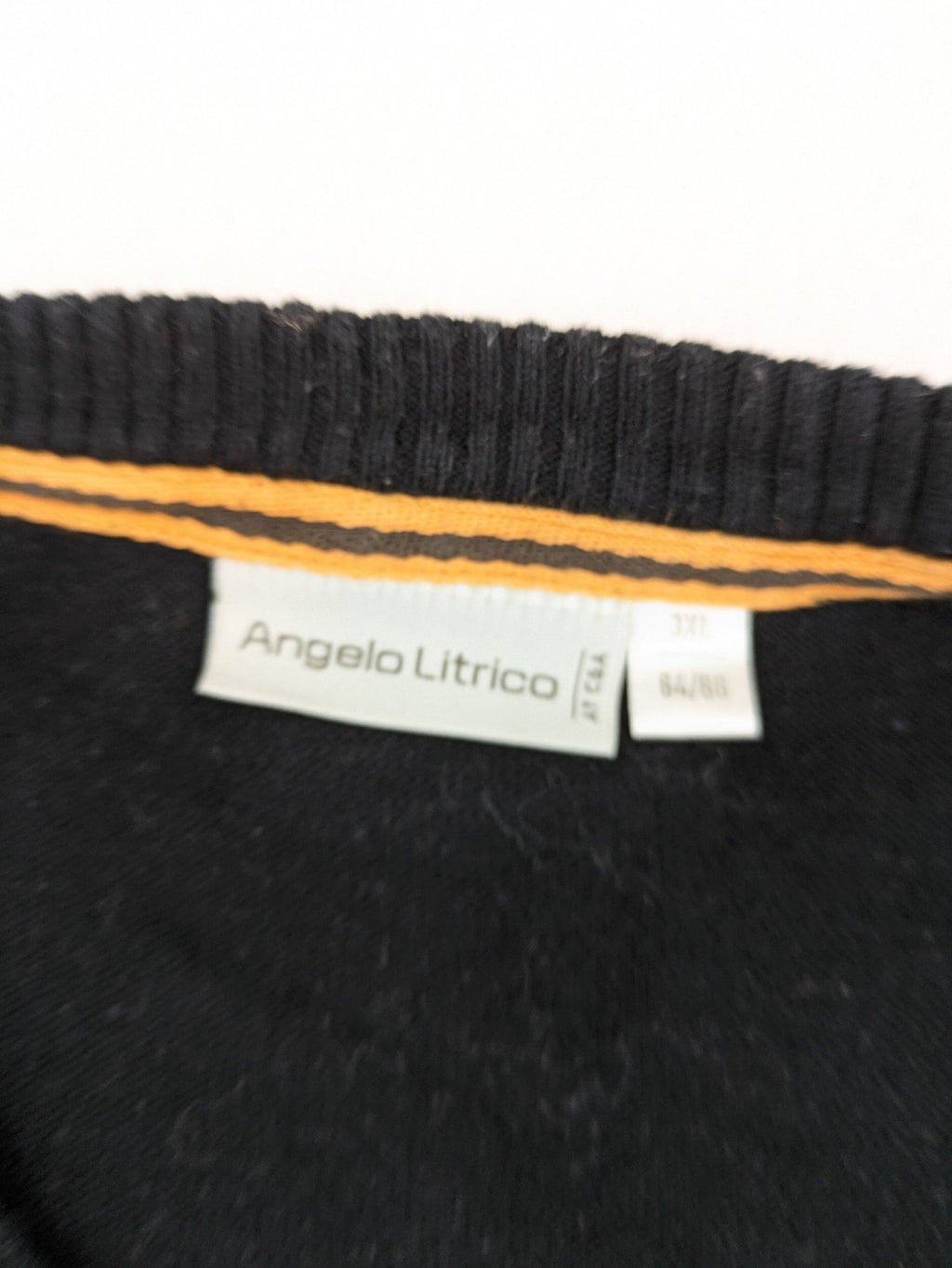 Angelo Litrico black knit jumper V-neck with tonal emblem and "Supreme Oil Quality" graphic.
