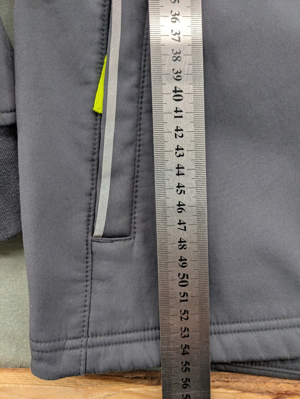 Yigga grey softshell coat with fleece lining, hood, and reflective details.