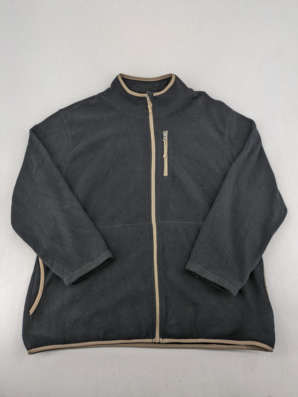 Crane beige and black fleece jacket full zip with cream accents and zippered pockets.
