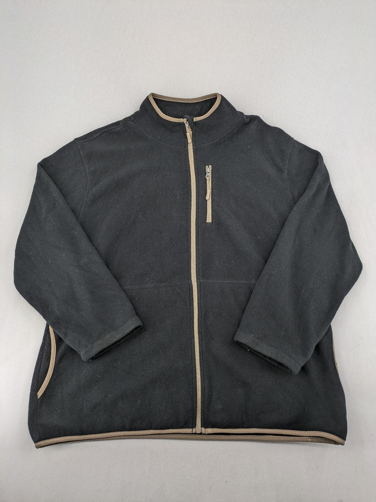 Crane beige and black fleece jacket full zip with cream accents and zippered pockets.