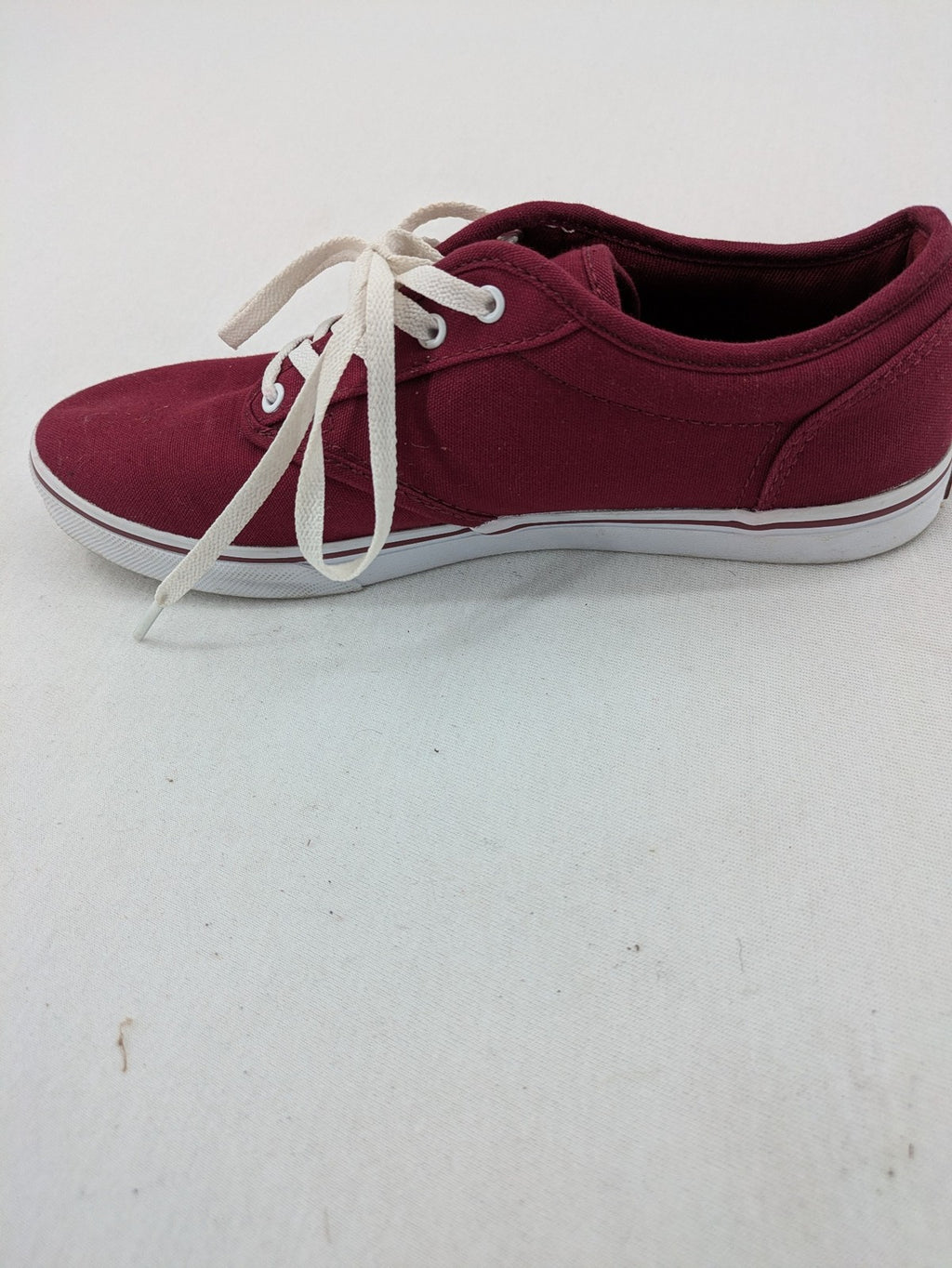 Vans low-top sneakers burgundy canvas with white logo and classic waffle sole.