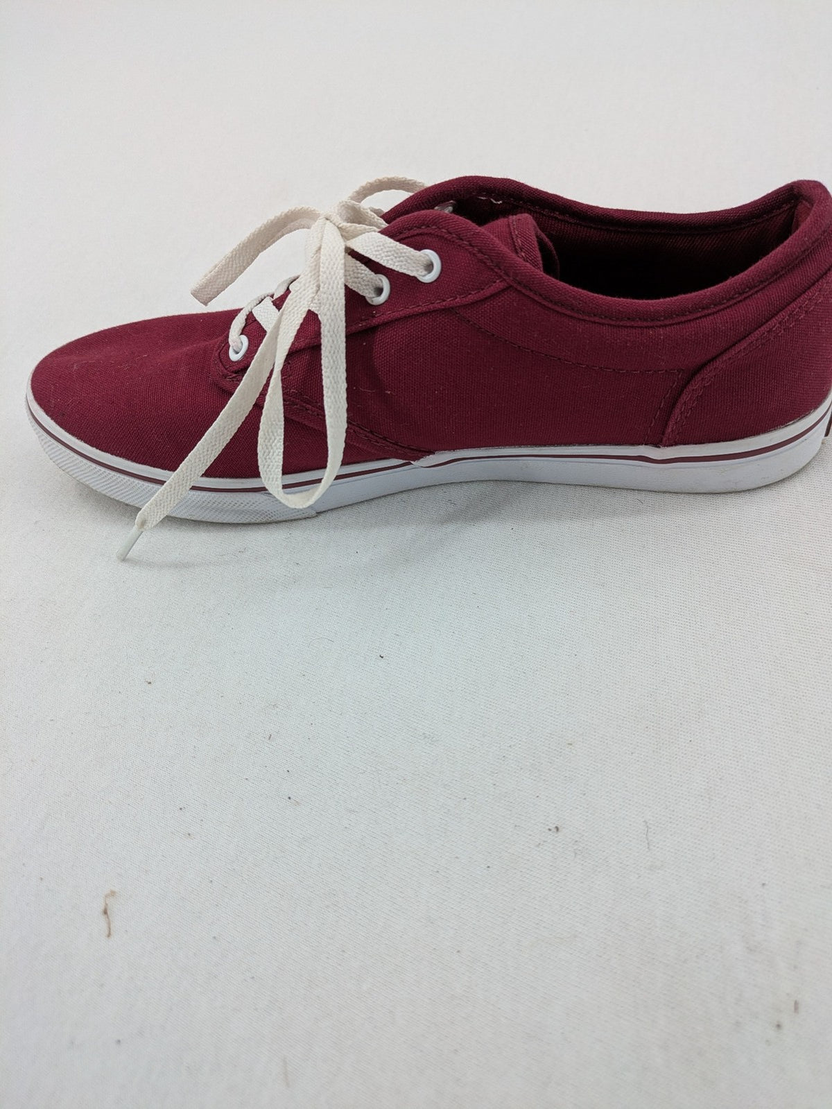 Vans low-top sneakers burgundy canvas with white logo and classic waffle sole.