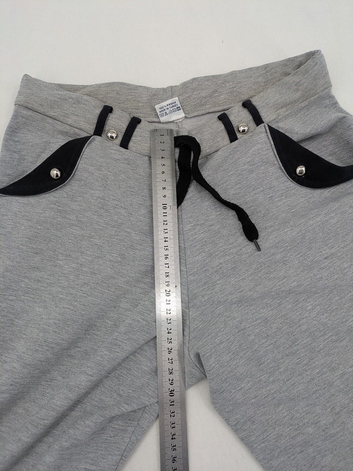 Falconhill grey jogging pants with elastic waistband, drawstring, and stylish black accent pockets.