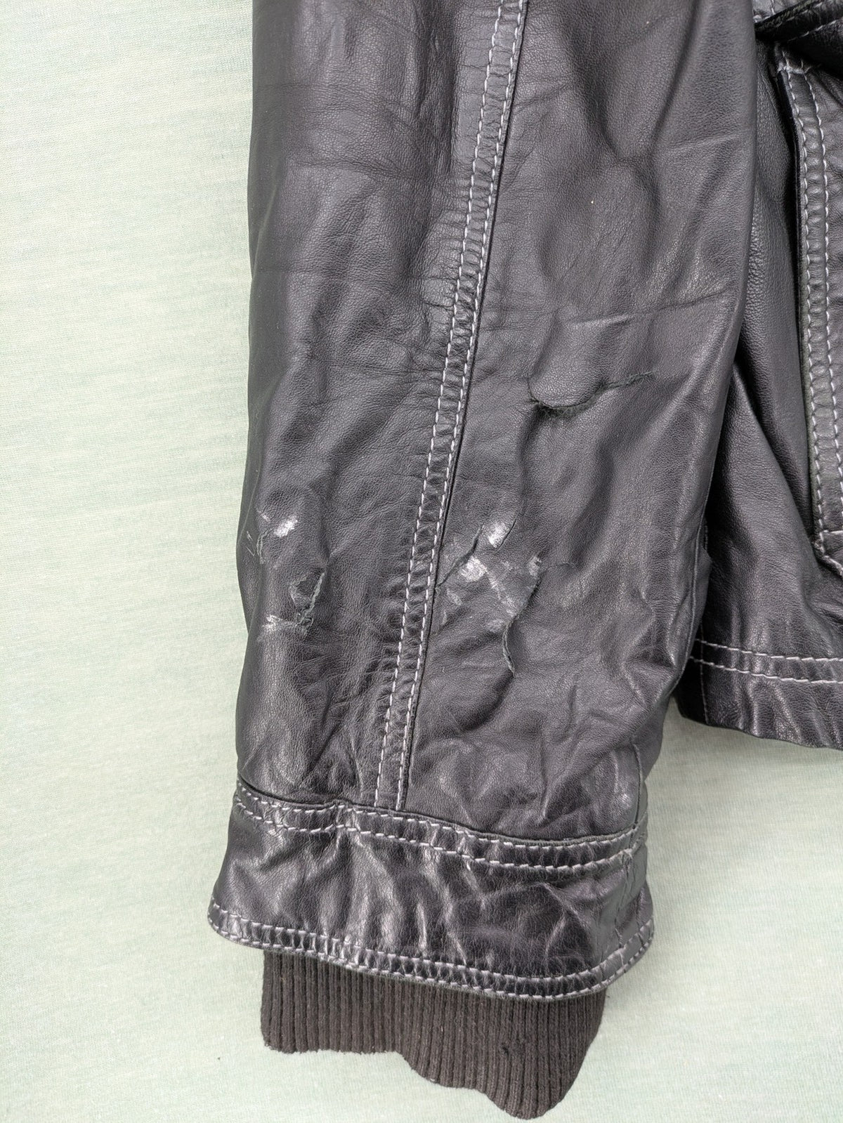 Tom Tailor black leather jacket vintage style with multiple pockets and contrast stitching.
