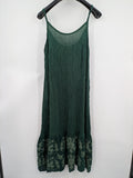 Boho green maxi dress with floral embroidery along tiered hem and adjustable spaghetti straps.