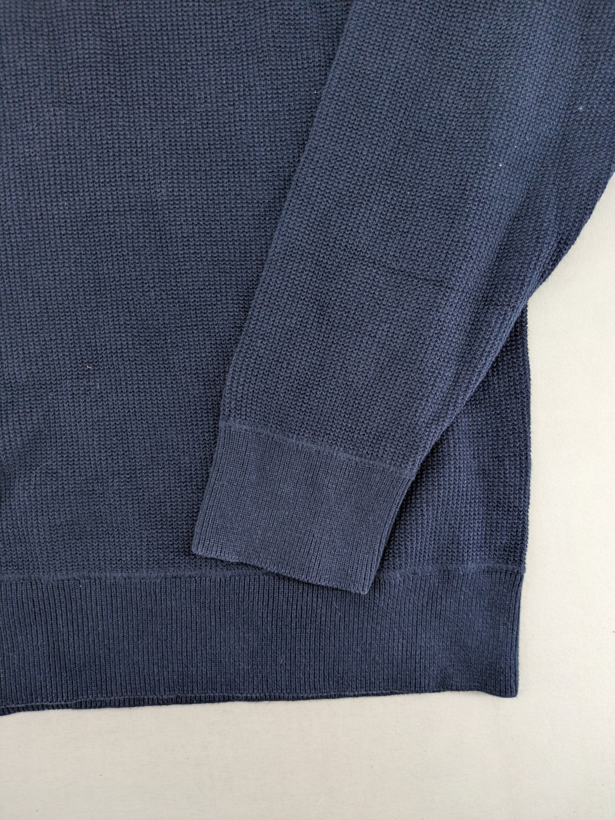 Carhartt navy turtle neck jumper waffle knit texture with subtle logo on sleeve.