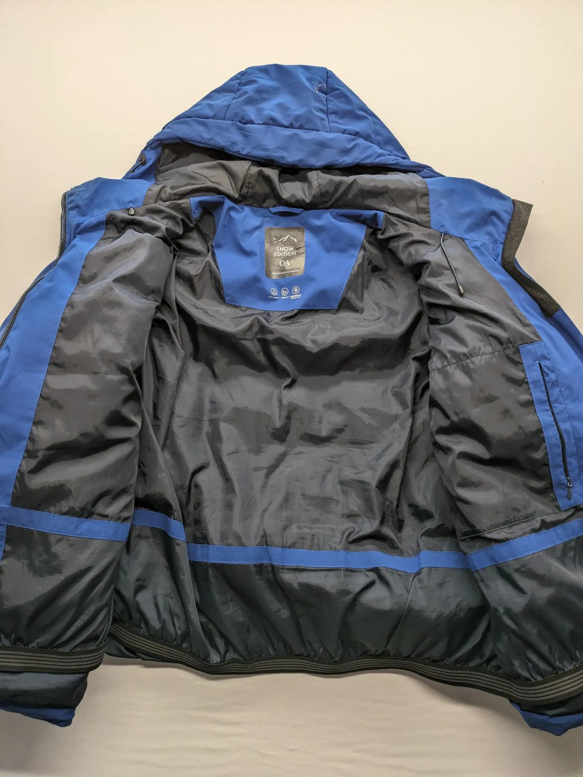 C&A blue winter jacket with hood, zip closure, and multiple pockets, used condition.