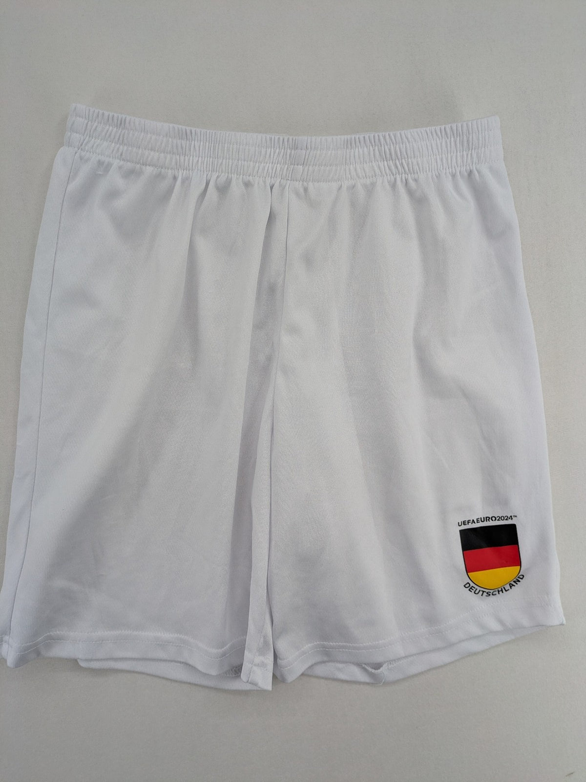 UEFA EURO 2024 white shorts with Germany crest and logo, elastic waistband, breathable material.