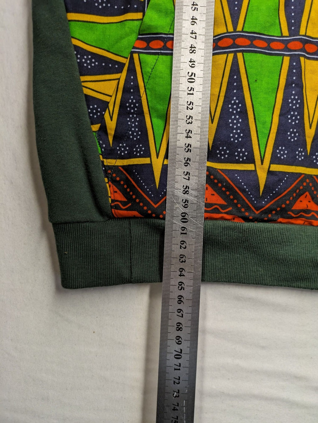 Diweye Creations multi turtle neck jumper with vibrant African print and soft green material.