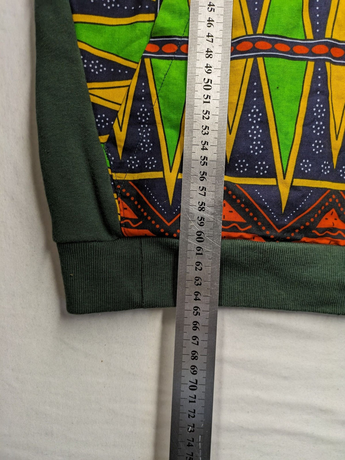 Diweye Creations multi turtle neck jumper with vibrant African print and soft green material.