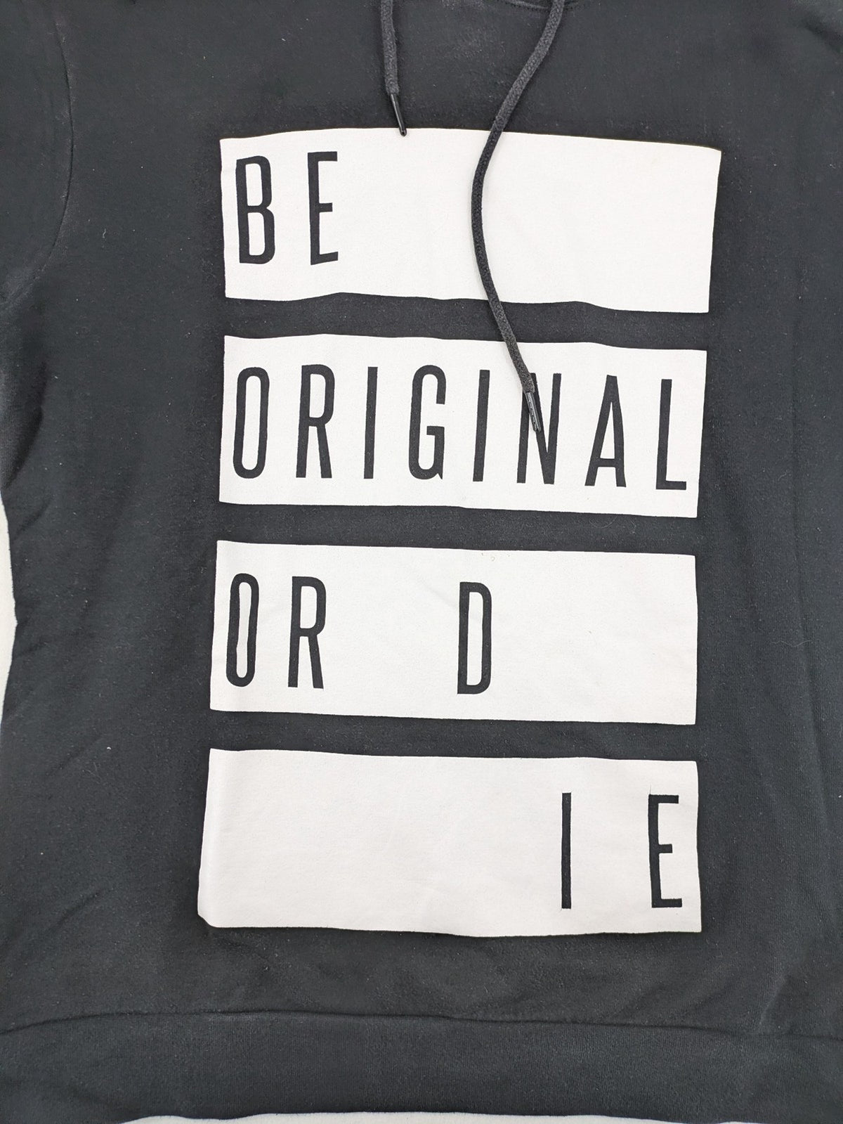 FSBN black hoodie with "BE ORIGINAL OR DIE" graphic print, slim fit, cotton-polyester blend.