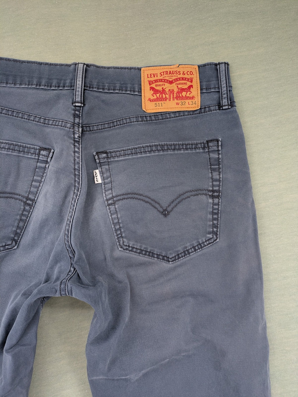 Levi's blue slim fit jeans with faded wash and classic 5-pocket design.
