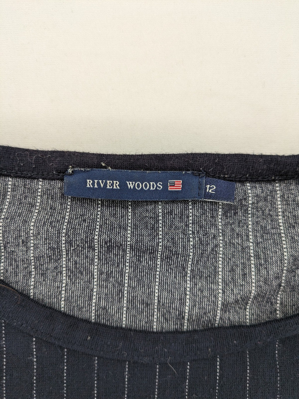 RIVER WOODS navy long sleeve top with white pinstripes and red "I AM très jolie" slogan.
