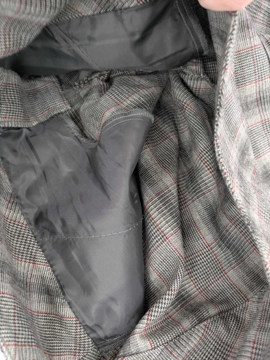 Lindex grey checkered bermuda shorts with red accents, high waist, decorative button detail.