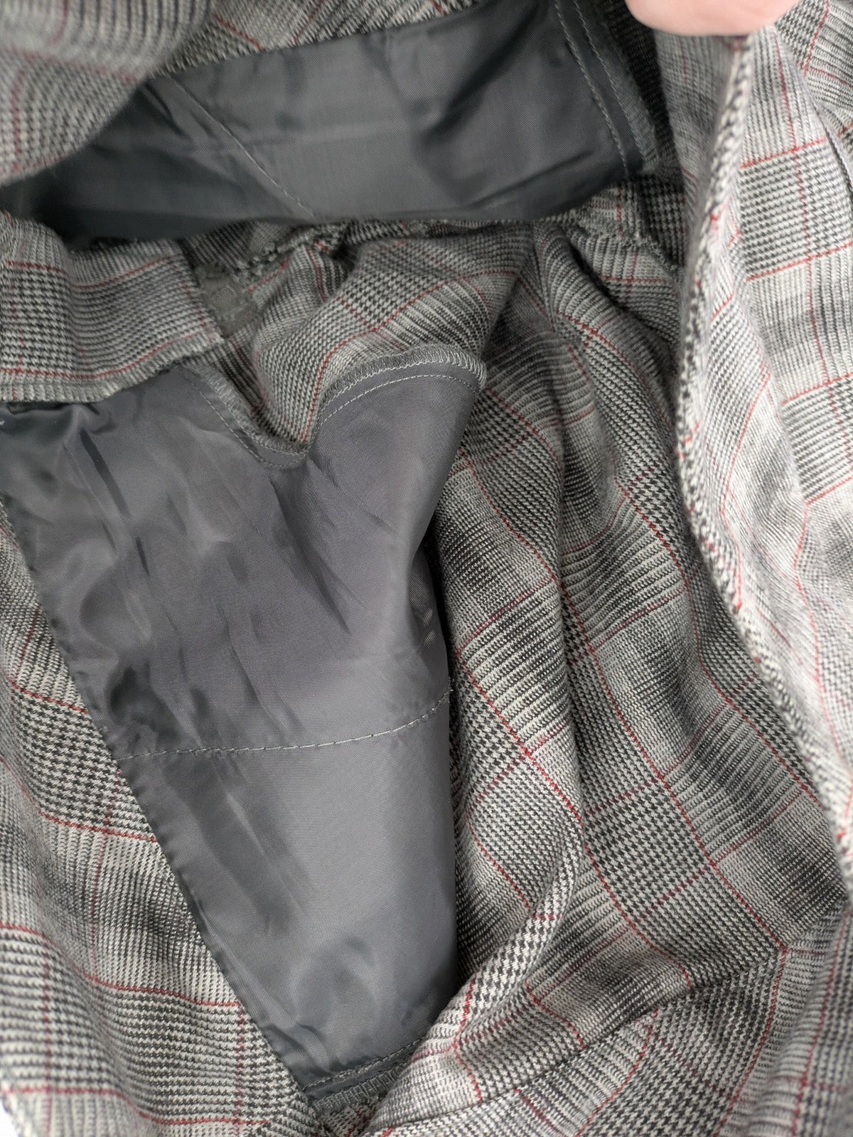 Lindex grey checkered bermuda shorts with red accents, high waist, decorative button detail.