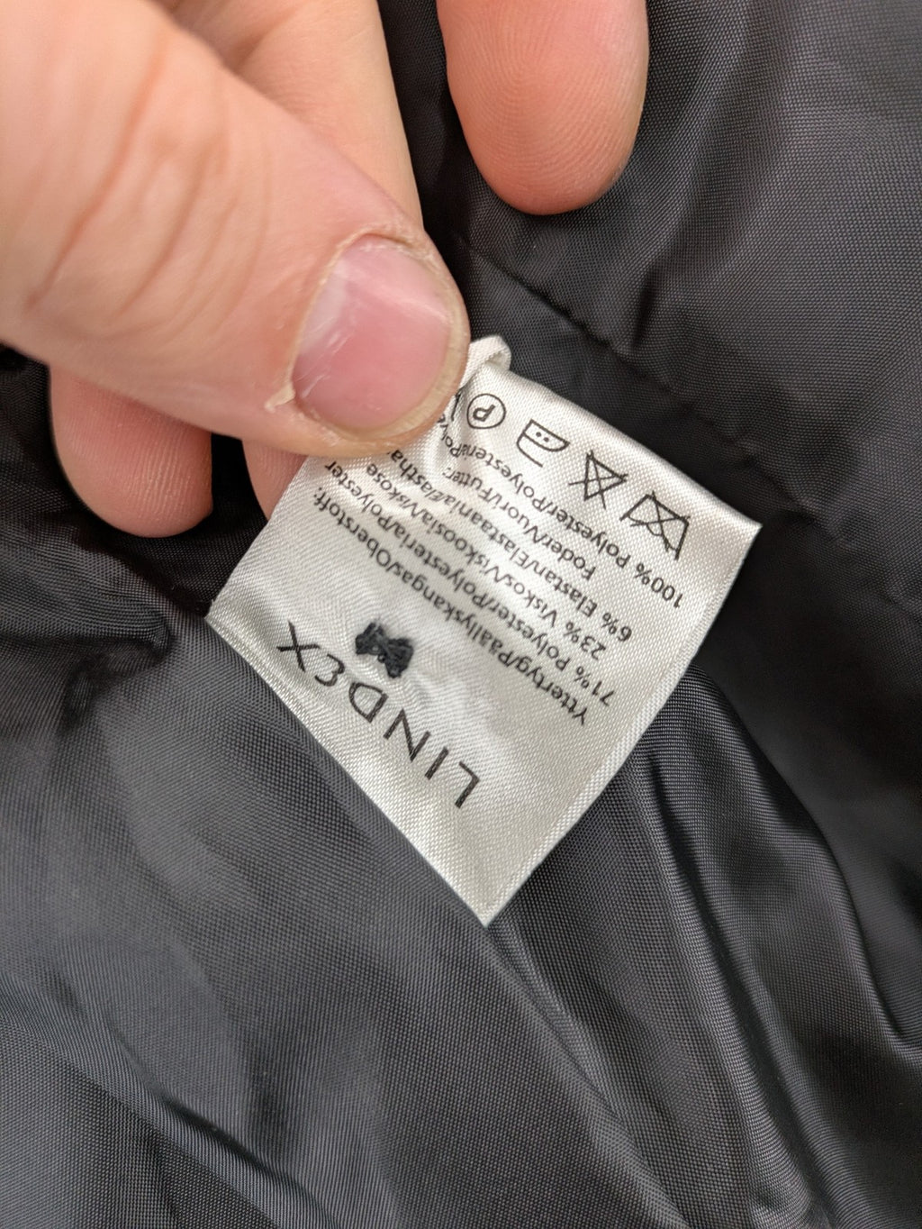 Lindex black blazer coat two-button design with subtle embroidery and tailored silhouette.